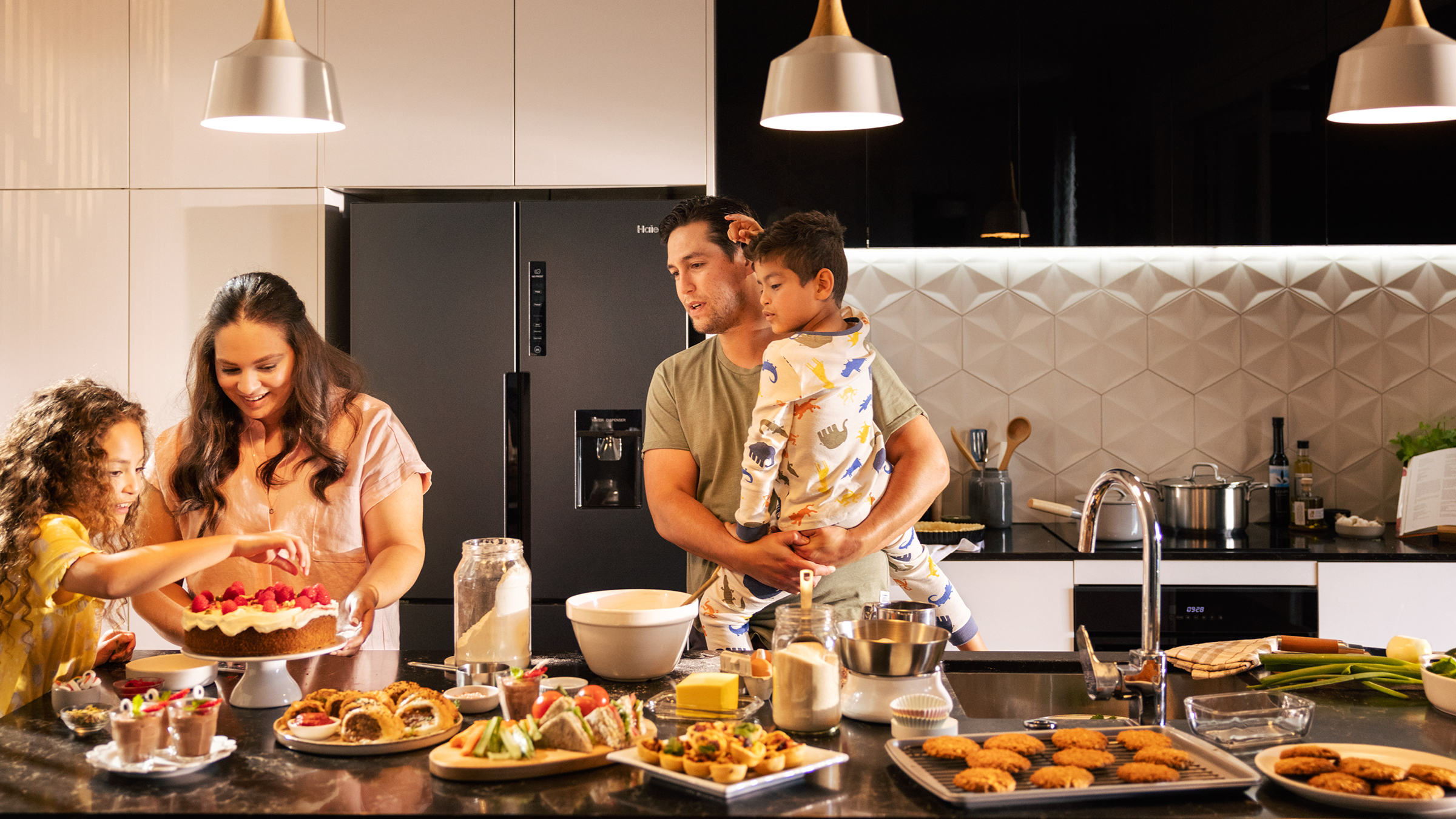 Family in kitchen near induction cooktop