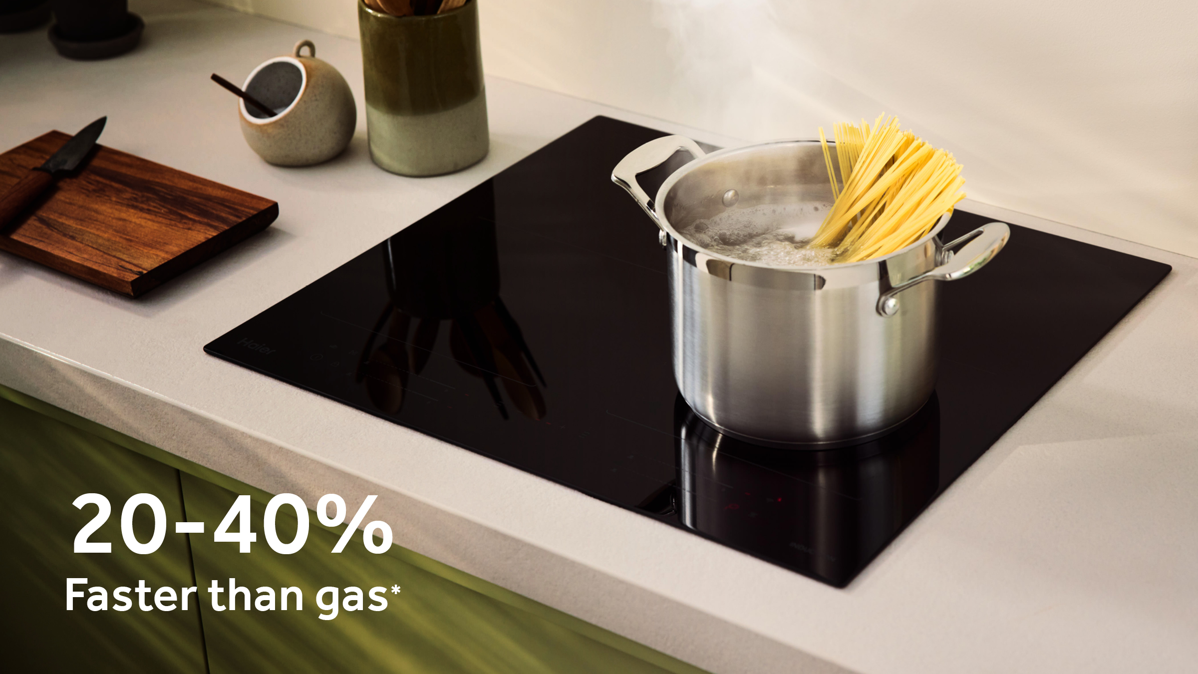 Pot boiling water on induction cooktop with 20–40% faster than gas text