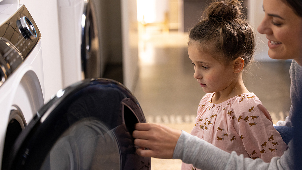 A child learning how to use a dryer