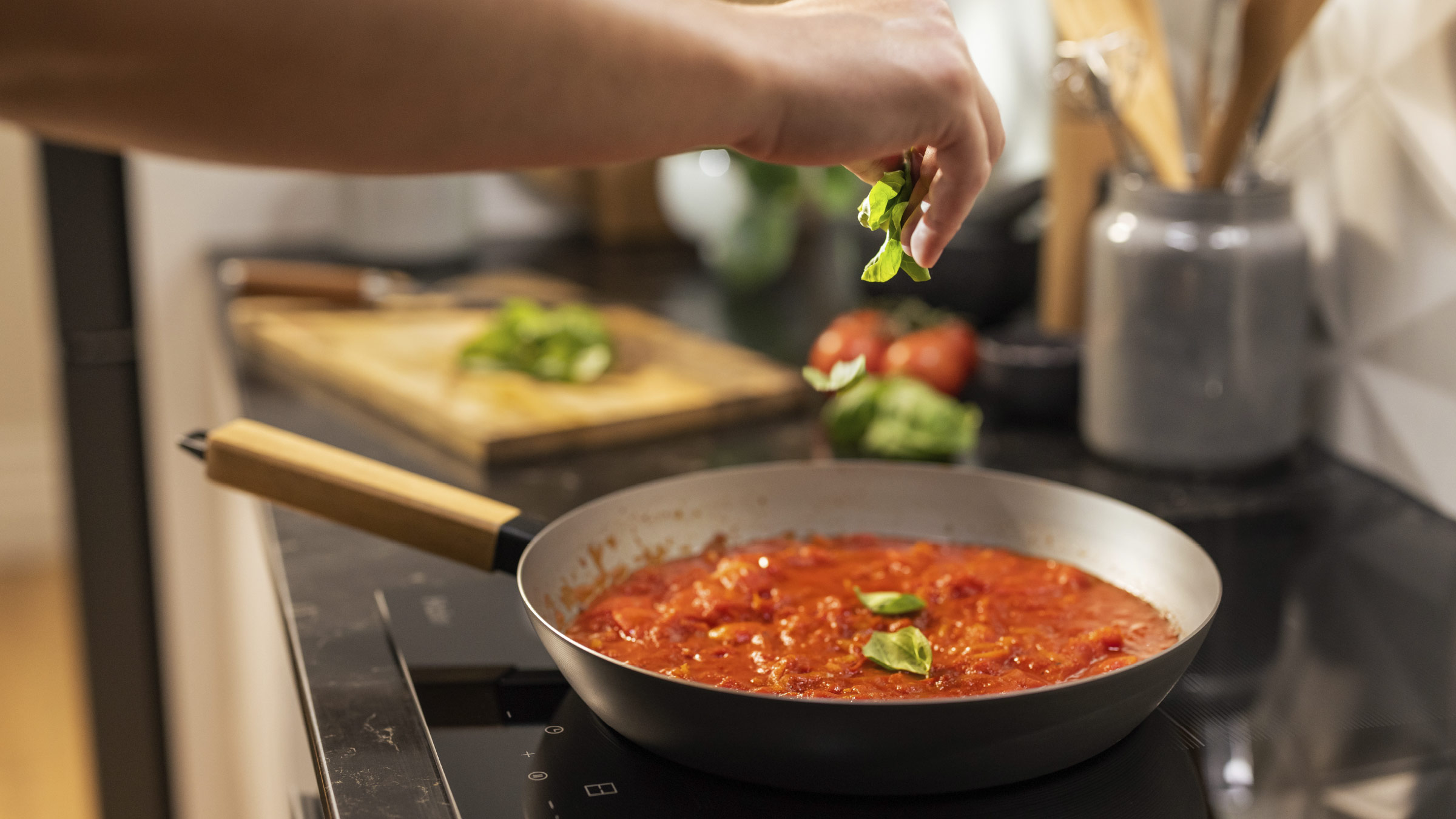 Cooking tomato and basil on Haier's new low current induction cooktop.
